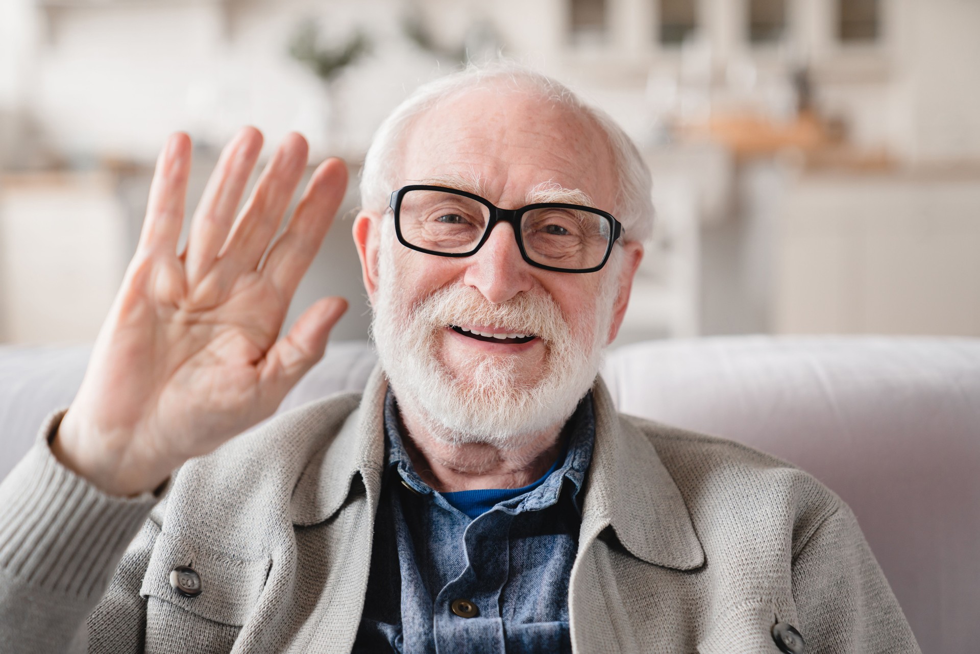 Front view. Videocall conference conversation online. Caucasian old elderly senior man grandfather looking at camera, talking with friends, grandchildren, social distance concept